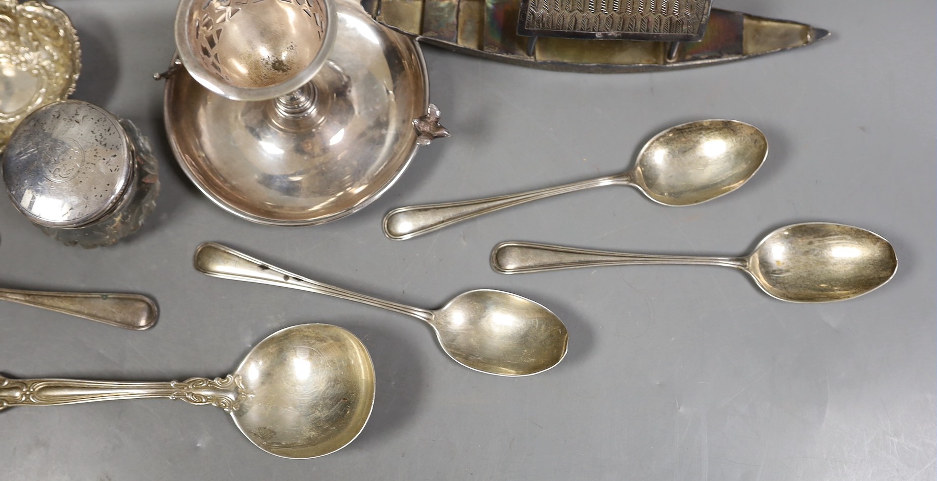 Miscellaneous silver ware including a mounted cigarette box, mounted posy vase, egg cup stand, late Victorian circular box and cover, repousse dish, eight sterling items including flatware and three other items.